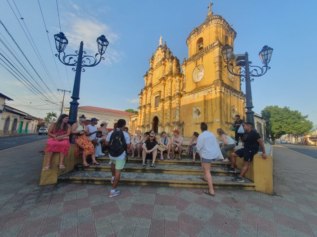 Group sitting during the Original Free Walking Tour in Leon Nicaragua with Mono Loco Adventures