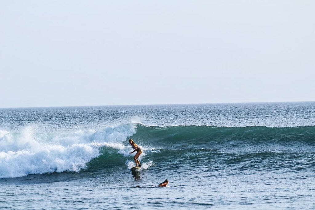 Guy surfing the waves at Popoyo