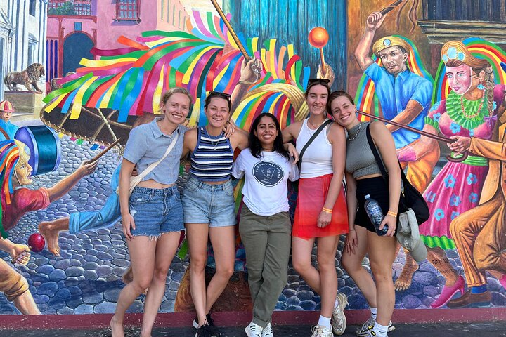 Group in front of a mural during the street art tour in Leon